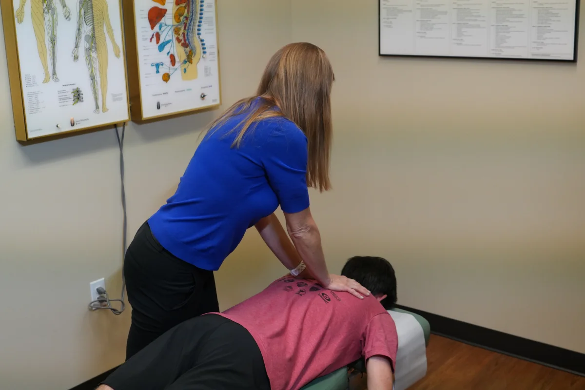 Dr. Nicole Edwards, D.C. performing a back adjustment